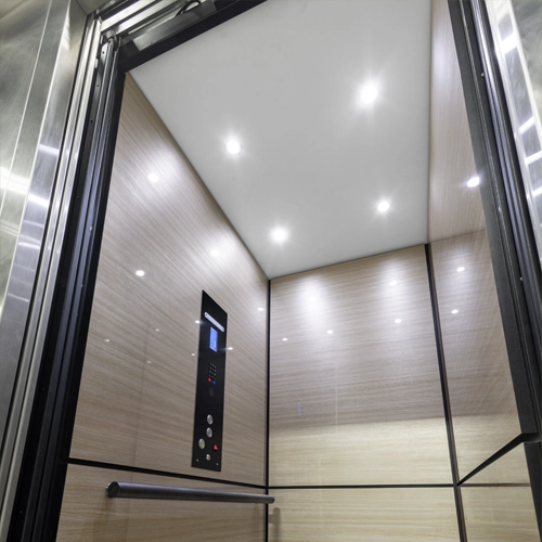 Bright white ceiling paired with luxury mdf finish option in home elevator cab.