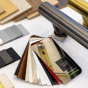 Various wood and metal samples laid out for home elevator cab customization.