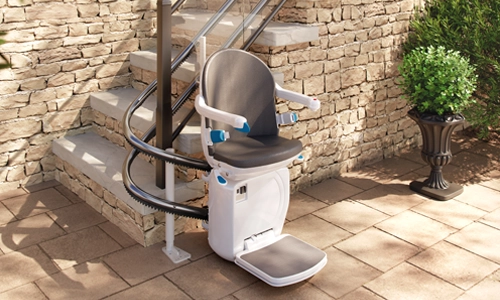 Handicare 4000 stair lift installed outdoors on a stone staircase