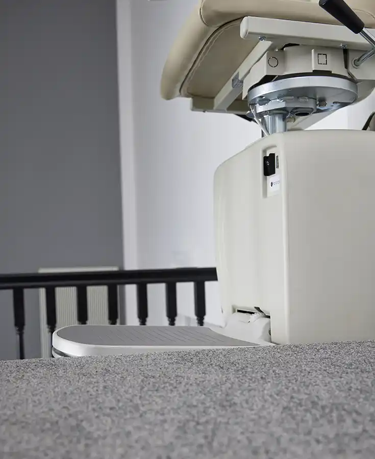 Handicare 4000 carriage and twin-rail track on carpeted stairs