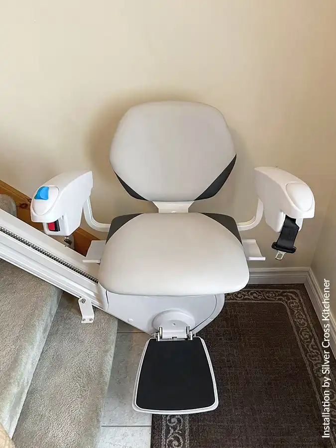 Front view of the Savaria K2 Plus stair lift on straight stairs