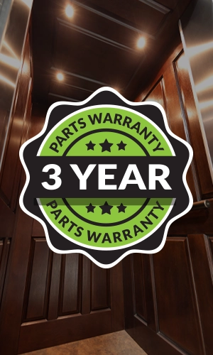 Elevator interior with wood paneling overlaid by a green ‘3‑year parts warranty’ badge.