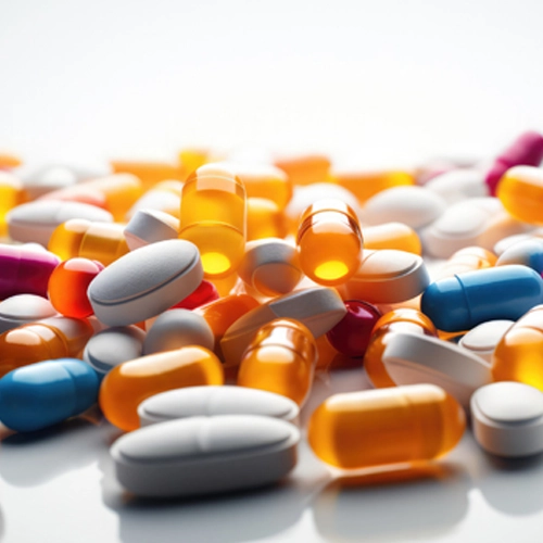 Assorted colored pills, intended for transport using a material lift.