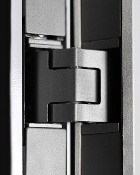 Close‑up view of an elevator gate hinge, showing the metal pivot mechanism between two vertical gate panels.