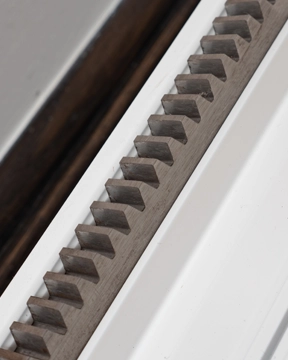 Rack and pinion gear track used in a stairlift drive system.