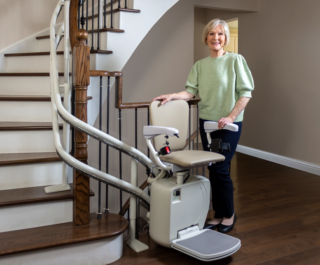 Elderly lady next to her curved stairlift